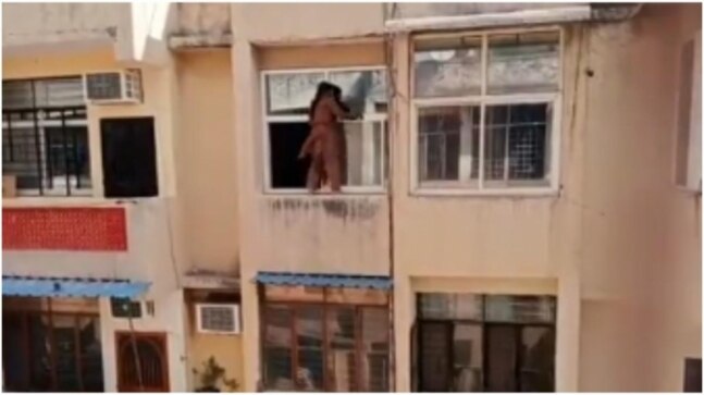Ghaziabad woman stands on fourth floor railing to clean window. Spine-chilling video goes viral