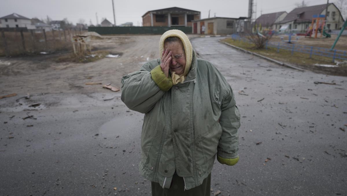 A woman cries outside houses damaged by a Russian airstrike, according to locals, in Gorenka, outside the capital Kyiv. (Photo: AP)