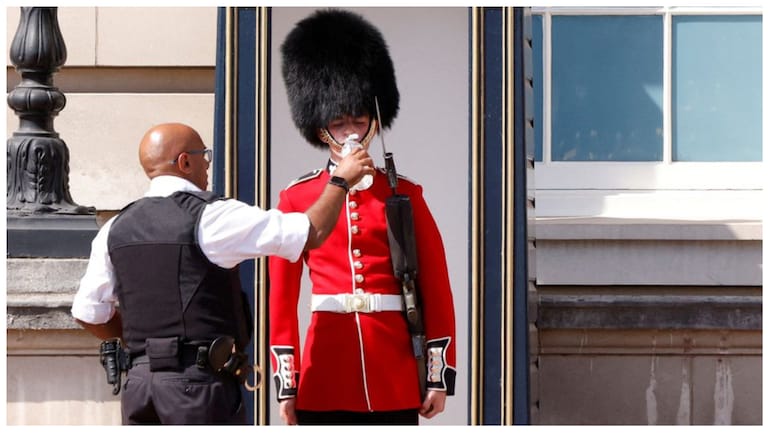 Queen's Guard receives water to drink outside London's Buckingham palace amid heatwave A member of the Queen's Guard receives water to drink outside Buckingham Palace in London