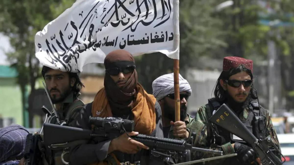 Taliban fighters display their flag as they patrol in Kabul, Afghanistan. (Photo: AP)