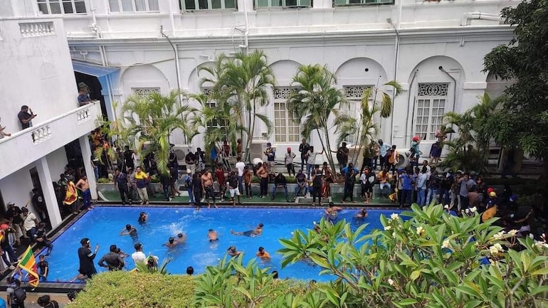 A screengrab shows agitators taking a swim at Sri Lanka President Gotabaya Rajapaksa's residence in Colombo on Saturday.
