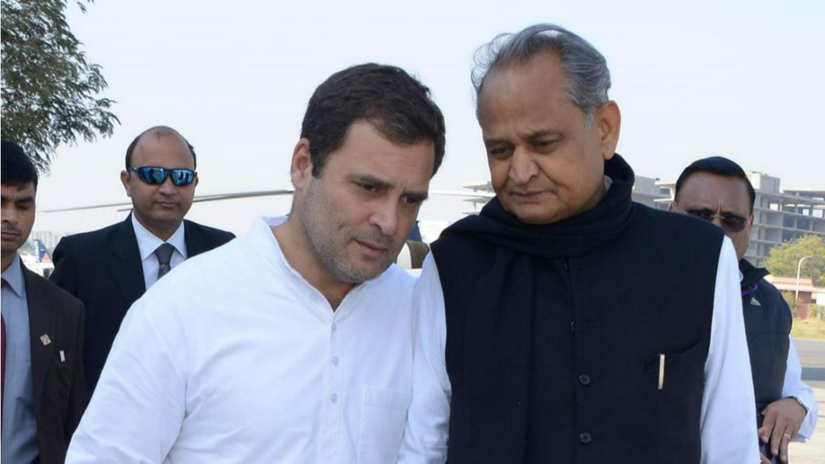 Rahul Gandhi (left) seen talking to Ashok Gehlot (right) wearing black jacket. 