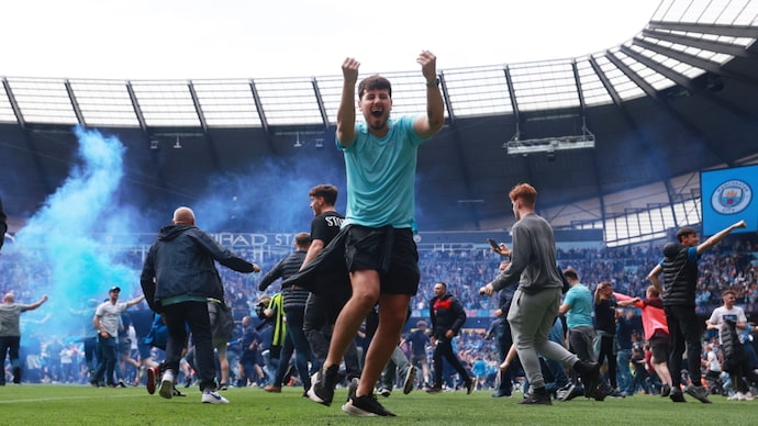 Manchester City fined by FA over pitch invasion to celebrate Premier League title win