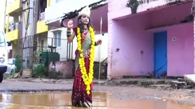 School girl dressed as Durga walks on road full of potholes in Karnataka’s Hubballi | Watch