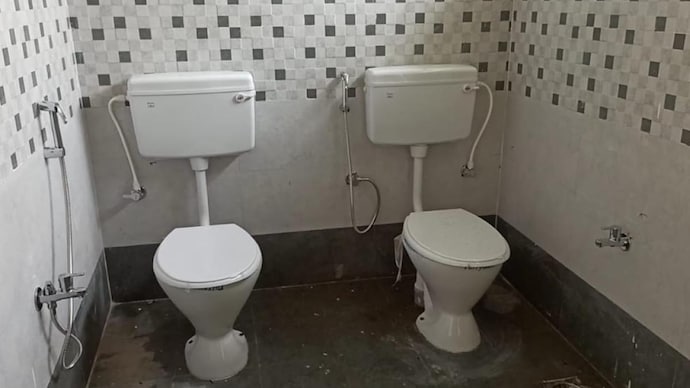 Image of 2 commodes inside one bathroom at an office building in