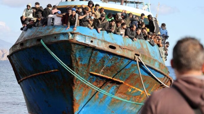 Migrants stand onboard a fishing boat at the port of Paleochora, following a rescue operation off the island of Crete, Greece (Photo: Reuters)