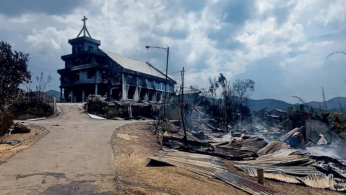 SHADES OF DYSTOPIA: Remains of a church and houses burned down in ethnic clashes at Langching village, 45 km from Imphal. (Photo: AFP)