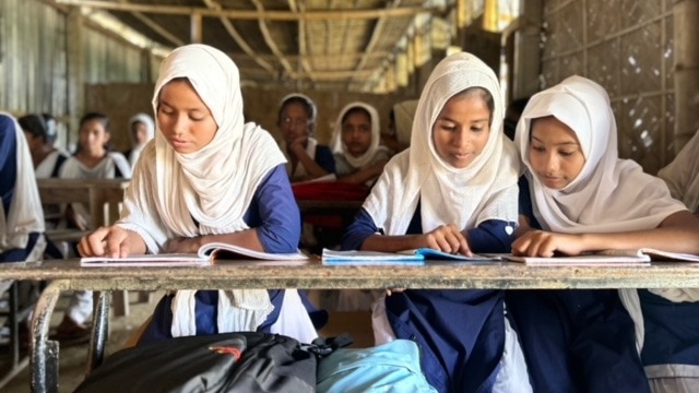 Students studying in classroom at Dotialbari High School.