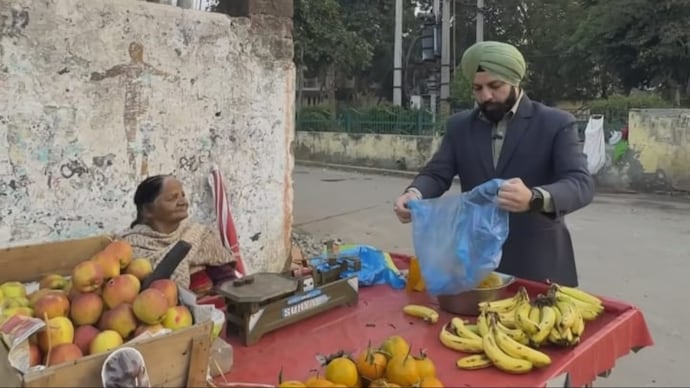 man buying fruits from elderly woman