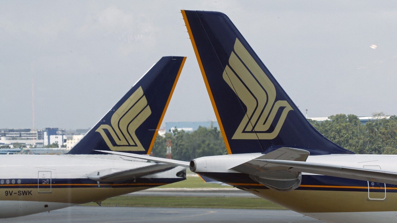 Singapore Airlines (SIA) planes sit on the tarmac in Singapore's Changi Airport March 3, 2016