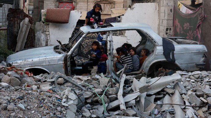 Palestinian children gather near a destroyed vehicle amid the Israel-Hamas conflict in Khan Yunis, southern Gaza Strip, October 27, 2024. Reuters/Mohammed Salem Palestinian children gather near a destroyed vehicle amid the Israel-Hamas conflict in Khan Yunis, southern Gaza Strip, October 27, 2024. Reuters/Mohammed Salem