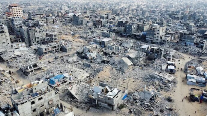 A drone view shows Palestinians walking past the rubble of houses and buildings destroyed in Israeli strikes during the war, following a ceasefire between Israel and Hamas. (File photo: Reuters) Israel-Hamas ceasefire