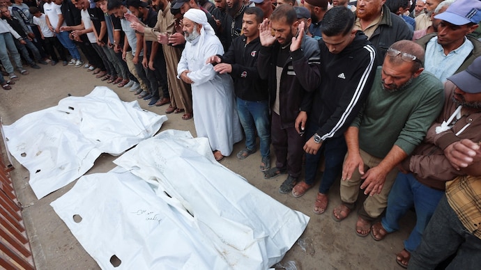 Mourners pray as they attend the funeral of Palestinians who, according to medics, were killed in overnight Israeli strikes, at Nasser Hospital in Khan Younis in the southern Gaza Strip. Mourners pray as they attend the funeral of Palestinians who, according to medics, were killed in overnight Israeli strikes, at Nasser Hospital in Khan Younis in the southern Gaza Strip.