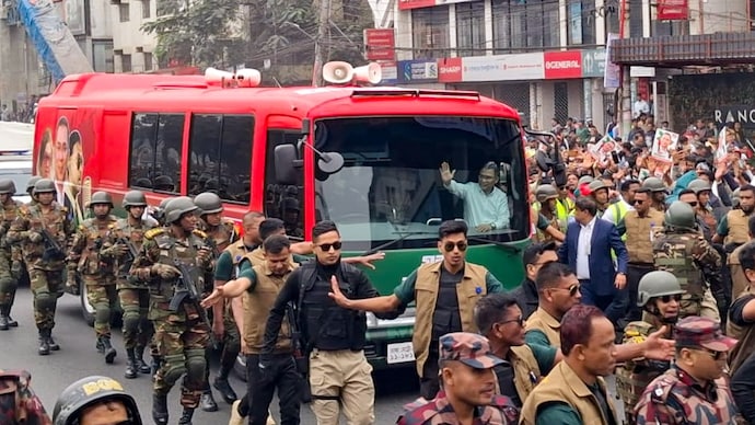 Bangladesh ist Party (BNP) Acting Chairman Tarique Rahman waves to supporters as he is escorted by security personnel upon his return after over 17 years in self-exile, in Dhaka. Bangladesh ist Party (BNP) Acting Chairman Tarique Rahman waves to supporters as he is escorted by security personnel upon his return after over 17 years in self-exile, in Dhaka.