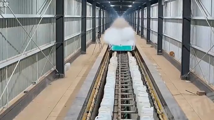 Footage aired by China’s state broadcaster CCTV showed the test vehicle—appearing as a streamlined chassis—racing along the track at high speed, briefly visible as a blur and leaving smoke in its wake. (Screengrab/X@ChinaDaily)) China Maglev hyperloop test