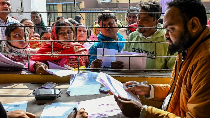 People get their documents verified during hearings under the Special Intensive Revision (SIR) of electoral rolls, in Nadia, West Bengal. (PTI photo) People get their documents verified during hearings under the Special Intensive Revision (SIR) of electoral rolls, in Nadia, West Bengal. (PTI photo)