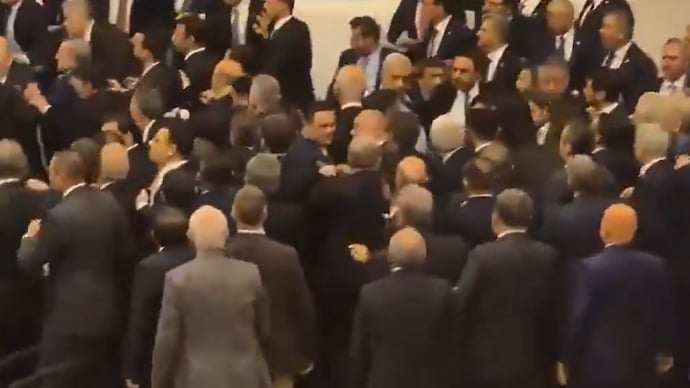 X) Footage from the chamber showed lawmakers pushing and shoving each other, with some throwing punches as tensions spilled over into violence.