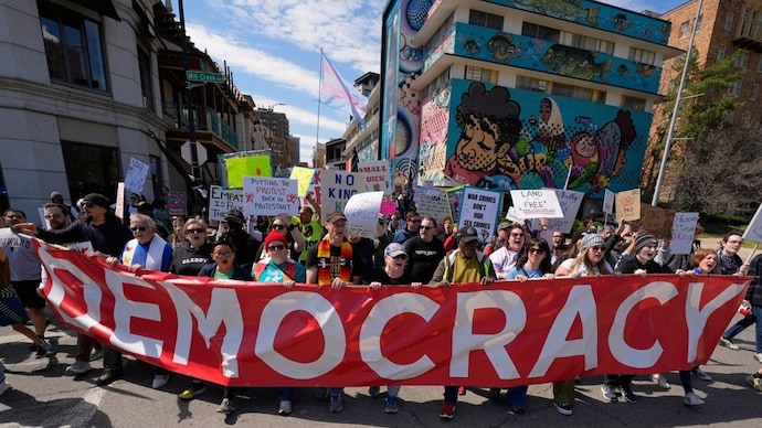 Demonstrators march through the Country Club Plaza shopping district during a "No Kings" protest Saturday, March 28, 2026, in Kansas City. (Photo- AP)