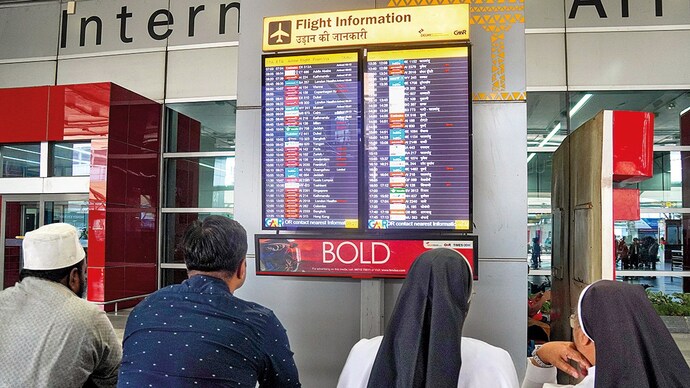 TRAVEL ANXIETY: Passengers check delayed Middle Eastbound flights at IGI Airport in Delhi, Mar. 16. (Photo: PTI)