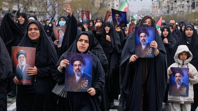 Demonstrators holding posters of Mojtaba Khamenei march during the annual anti-Israeli Quds Day Iran war