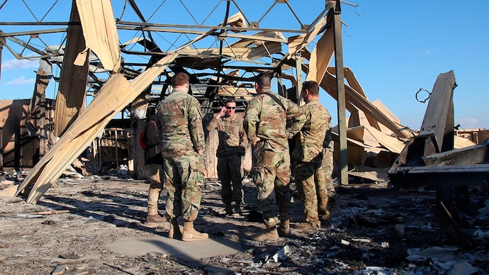 US soldiers stand at the spot hit by Iranian bombing at Ain al-Asad air base Iran war