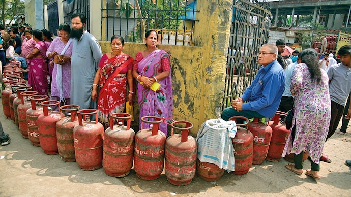 SUPPLY STRAIN: People queue up to get refilled LPG cylinders in Nagaon, Assam, Mar. 19. (Photo: AFP)