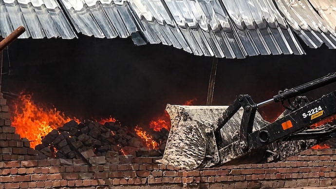 Bulldozers were deployed to douse the massive fire in UP's Harpur. (Photo: Screengrab/ANI)