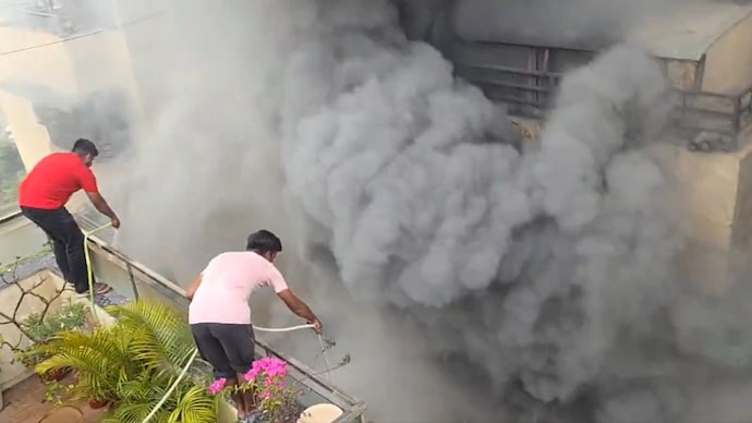 Gaur Green Avenue residents trying to douse the flames. Gaur Green Avenue residents trying to douse the flames.