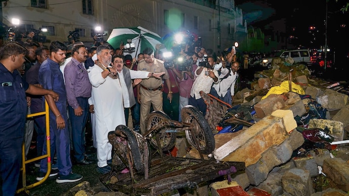 Karnataka Deputy Chief Minister DK Shivakumar visits the site of a wall collapse following heavy rain. (Image: PTI)