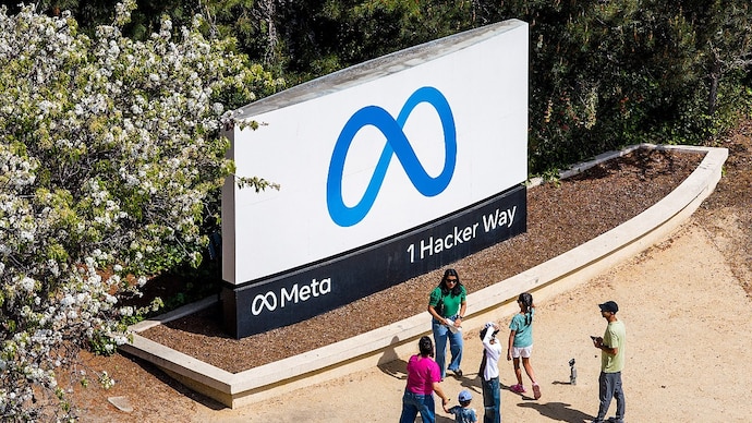 Visitors gather at a sign outside Meta headquarters on Thursday, March 26, 2026, in Menlo Park, Calif. (AP Photo/Noah Berger) Meta
