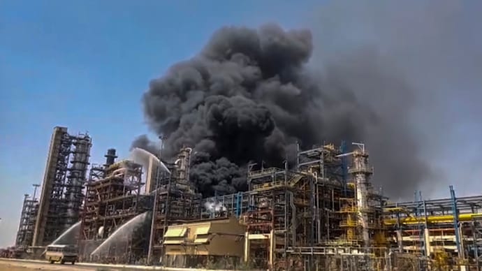 Firefighters douse a blaze after a fire broke out at the HPCL Pachpadra Refinery, in Balotra, Rajasthan. (Image: PTI) NIA team probes fire at Rajasthan refinery.