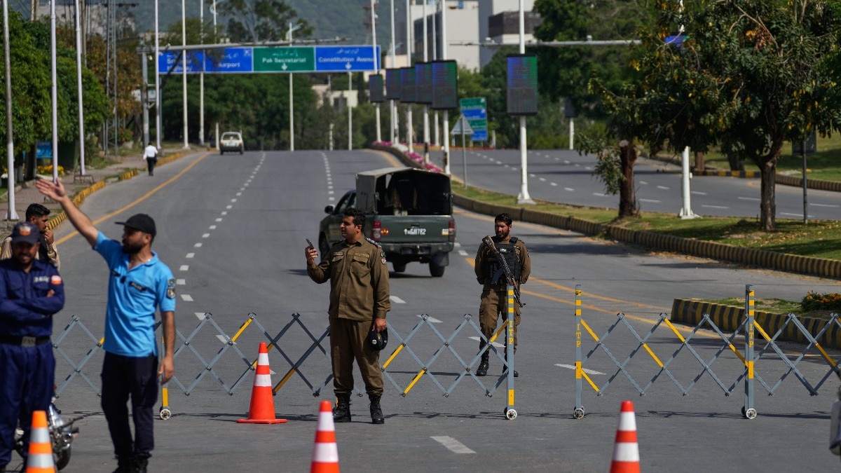 Police officers block roads in Islamabad after city was placed under a lockdown has hit the city's working classes hard, with many kicked out of rented accommodation and unable to work for a living. (Image: AP/Anjum Naveed) Pakistan capital Islamabad placed under lockdown.
