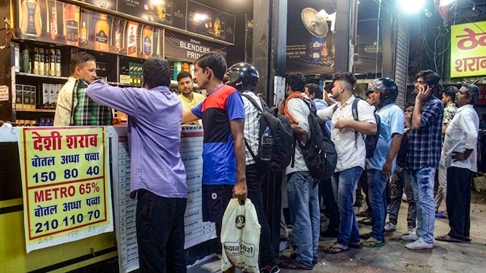 People standing in a queue to buy liquor bottles. (Photo: File) People standing in a queue to buy liquor bottles.