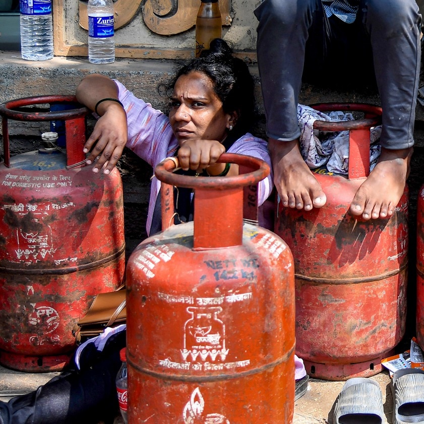 People wait in a queue to refill LPG cylinders in Mumbai on April 3. (PTI Image)