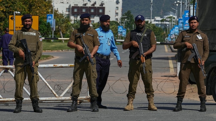 Police officers stand guard at a checkpoint to ensure security ahead of the second round of negotiations between the US and Iran, in Islamabad (Image: AP) Police officers stand guard at a checkpoint to ensure security ahead of the second round of negotiations between the U.S. and Iran, in Islamabad
