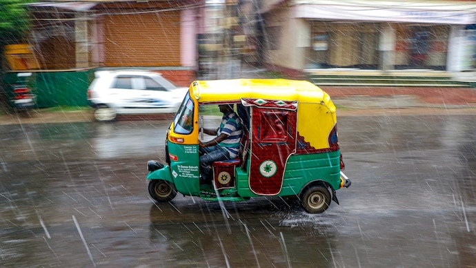 An auto rickshaw moves on a street during rain. (Photo: PTI) Rain and storm lower temperatures in north India: How long will the relief last?