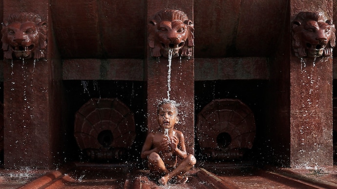 A boy cools himself off as he sits under a fountain in New Delhi. (Photo: Reuters) Summers are getting longer at a faster rate. Will 2026 prove it?