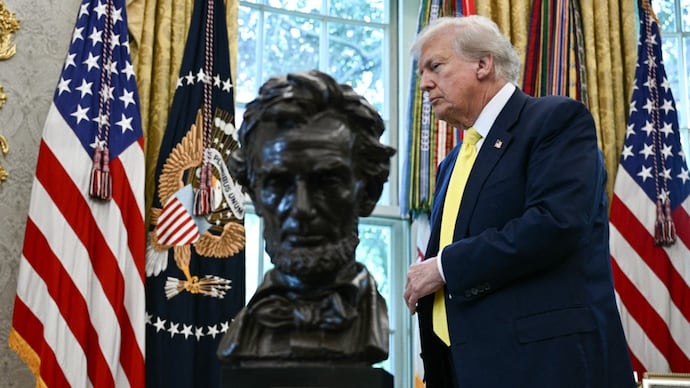 US President Donald Trump, alongside a bust of former President Abraham Lincoln, in the Oval Office. (AFP photo) US President Donald Trump, alongside a bust of former President Abraham Lincoln, in the Oval Office. (AFP photo)