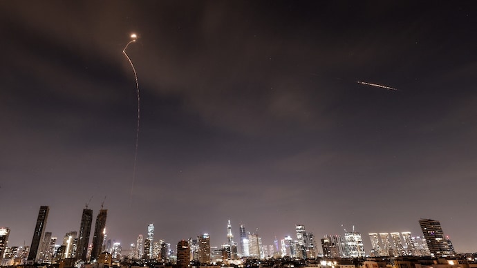 Streaks of light illuminate the sky during an interception attempt amid the US-Israeli conflict with Iran. (Reuters)