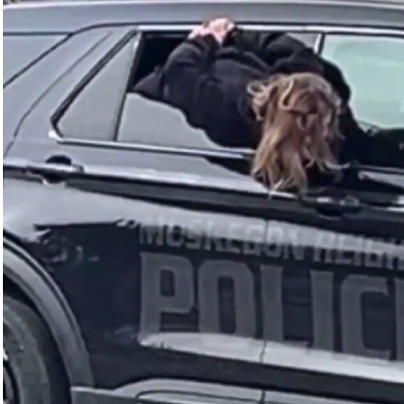 US woman squeezes out of police car window while handcuffed