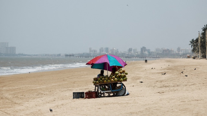 A vendor selling coconut water waits for customers at a beach on a hot day in Mumbai, Maharashtra. (Photo: Reuters) Why is Maharashtra hotter than Rajasthan? The reason explained