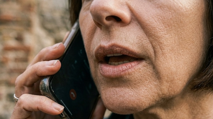 The woman, her husband, and their associate have been arrested in connection with case. (AI-generated representative image) Woman on phone