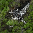 A crashed Cessna airplane is seen in a wooded area on Round Rock Road in Wimberley A crashed Cessna airplane is seen in a wooded area on Round Rock Road in Wimberley