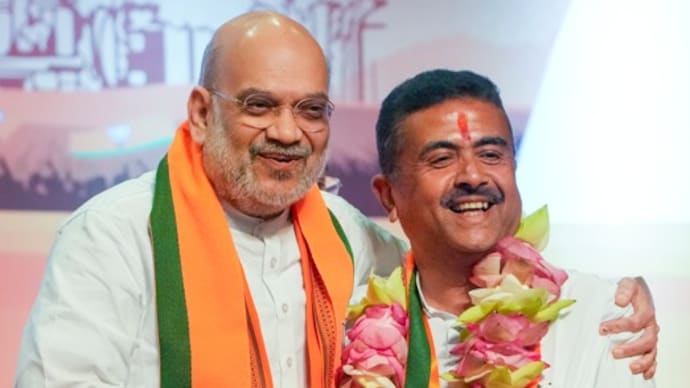 Home Minister Amit Shah felicitates West Bengal Chief Minister-designate Suvendu Adhikari after the BJP legislature party meeting in Kolkata on Friday. (Photo: PTI)