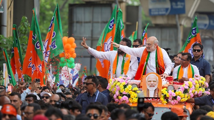 Union Home Minister Amit Shah during a roadshow at Behala Paschim for the West Bengal Assembly elections, in Kolkata. (Image: PTI) amit shah west bengal polls election result how bjp won in kolkata bhabanipur suvendu adhikari 2026 assembly