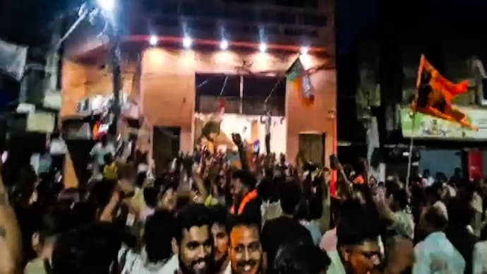 Devotees and BJP workers celebrate the opening of a Durga temple in West Bengal's Asansol following the party's victory in the Assembly polls on Monday.