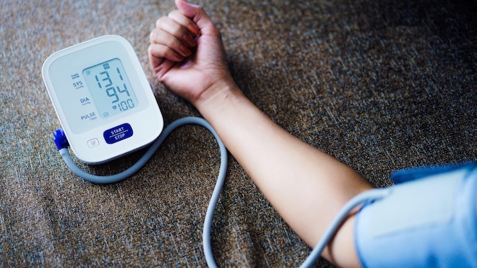 People with a family history of hypertension, diabetes or heart disease should get their blood pressure checked regularly, even if they feel healthy. (Photo: Getty Images) Asian Woman self blood pressure and heart rate measurement on blood pressure monitor recording the data at home