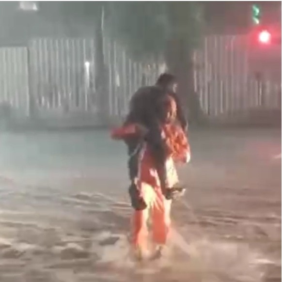 Bengaluru traffic cop carries specially-abled man across flooded road