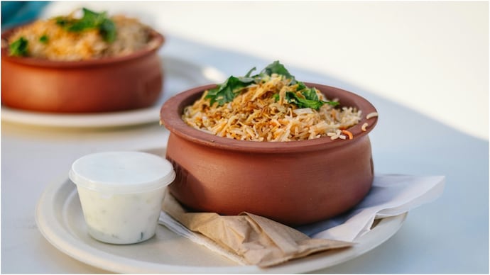 The Hyderabadi vs Lucknowi biryani debate has divided food lovers for years. One is bold and spicy, the other subtle and aromatic. Here’s what truly separates the two iconic biryani styles. (representative image) biryani swiggy 2025