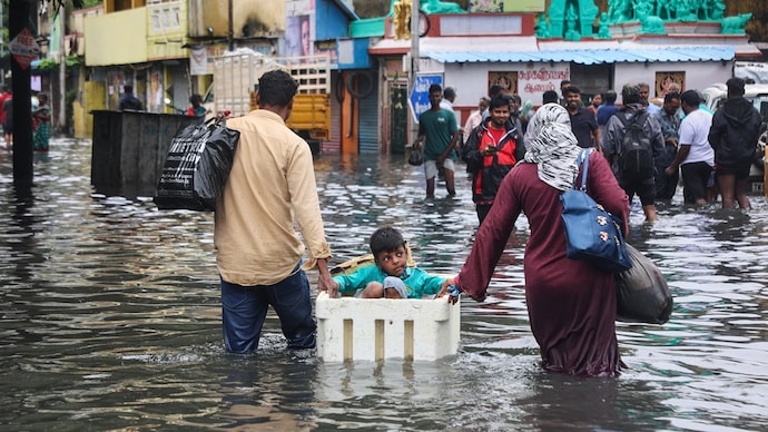 People wading through flooded roads after heavy rainfall. (Photo: PTI) Conditions set for historic El Nino this year. This Indian city is at high risk